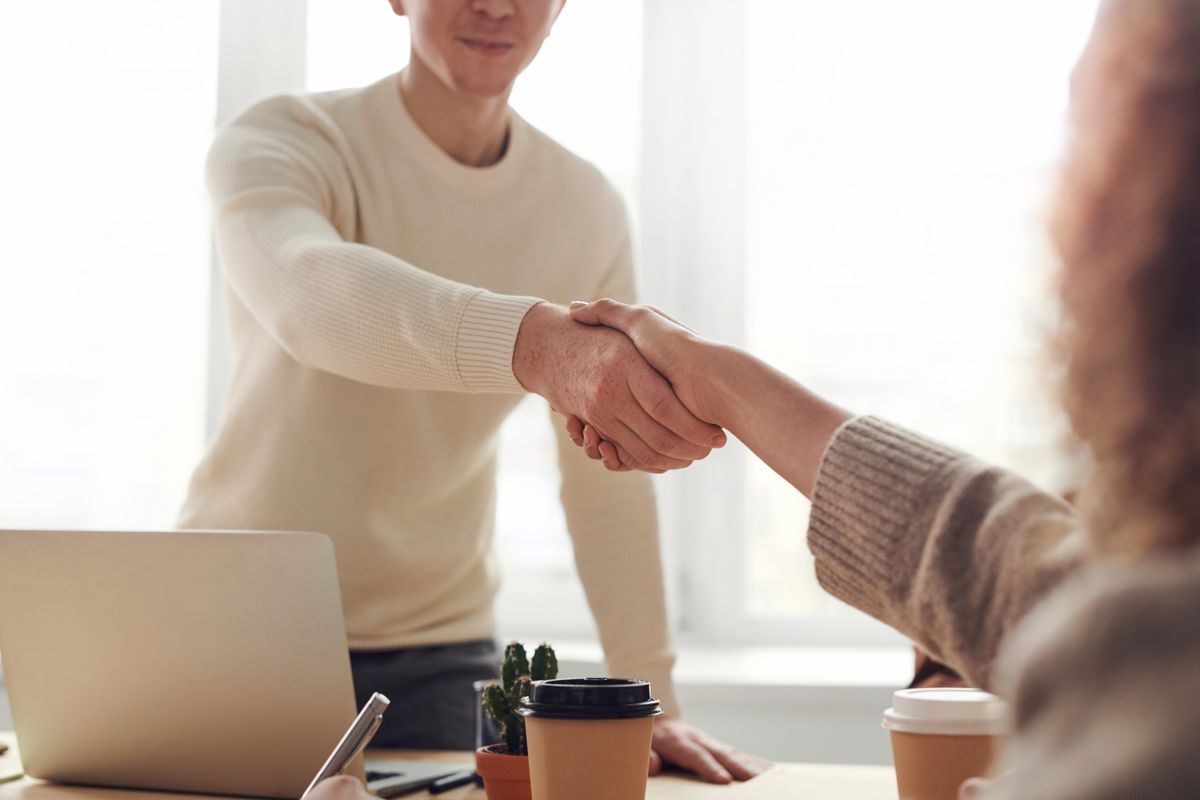 Client and Golden teams shaking hands after a delivery review